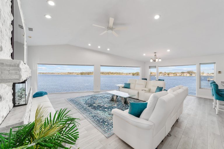 Bright waterfront living room with fireplace