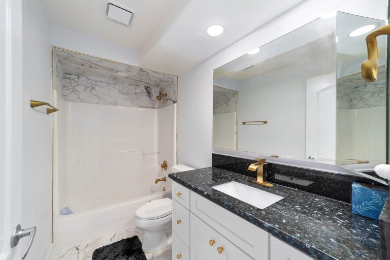 Guest bathroom with vanity and tub shower