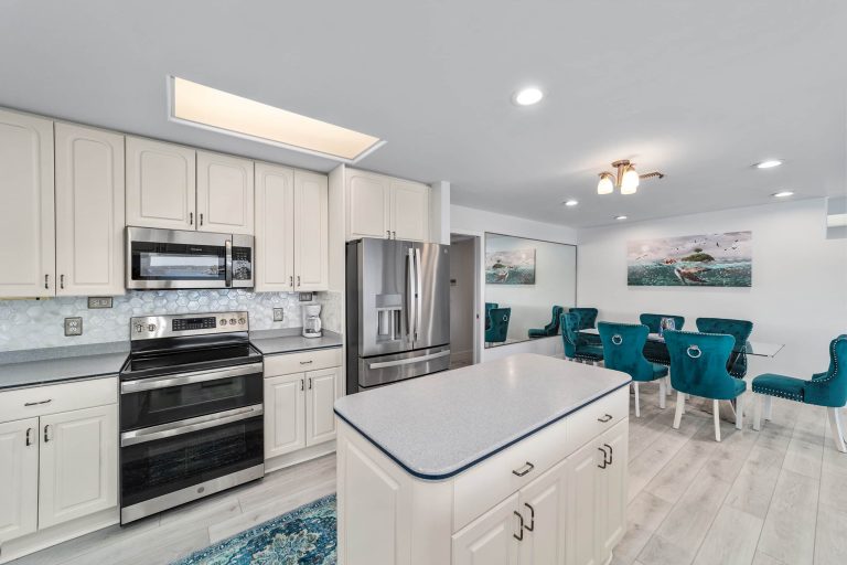 Kitchen with stainless appliances and breakfast bar