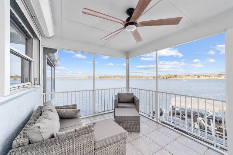 Screened balcony seating overlooking the river