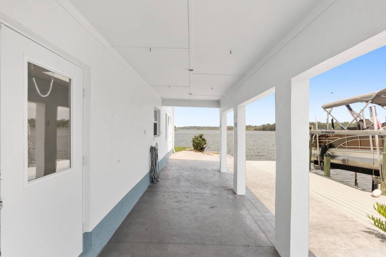 Covered lower patio beside the private dock
