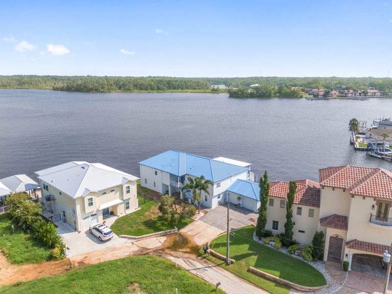 Aerial view of the home and neighboring waterfront