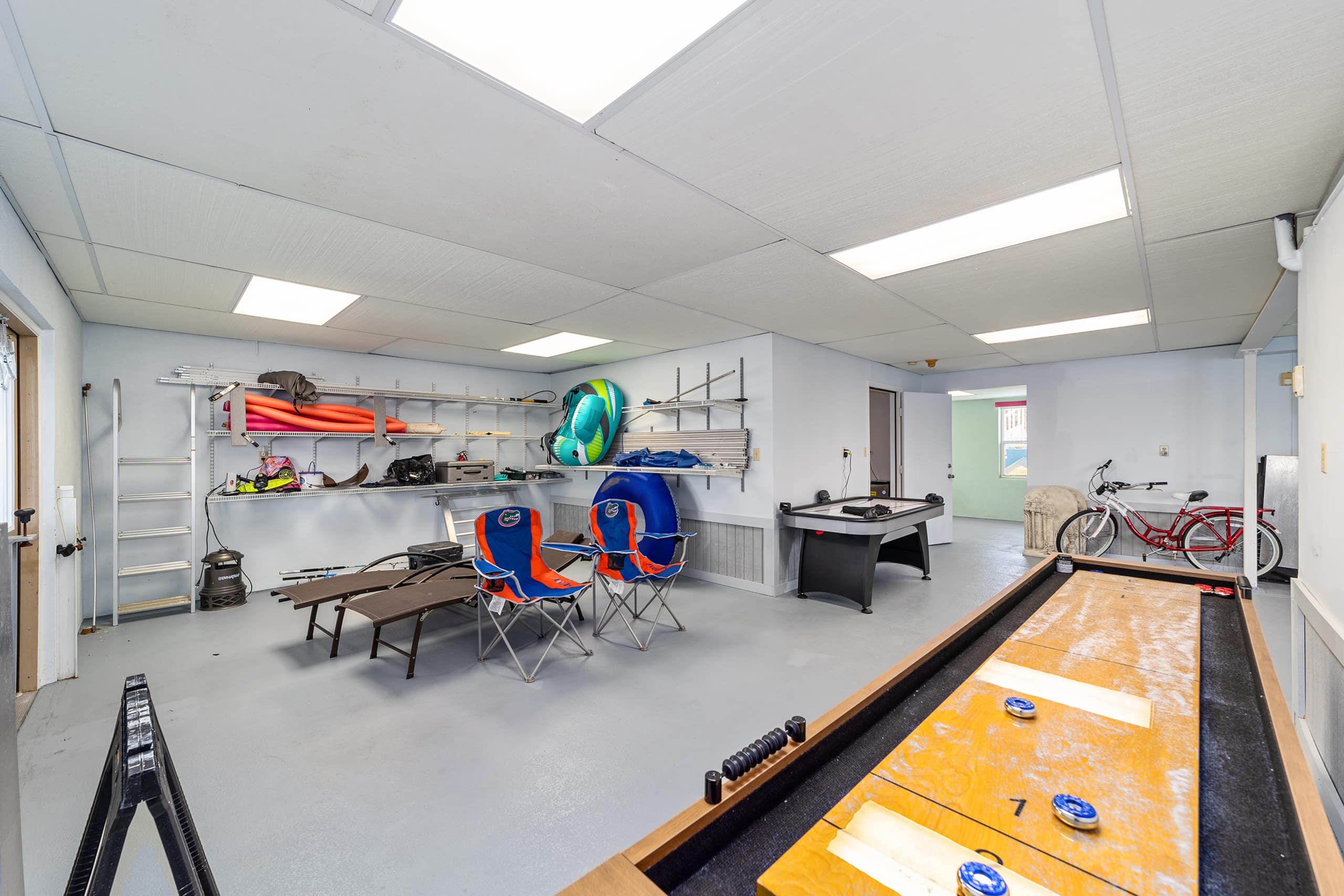 Large game room with pool table, games and kayaks