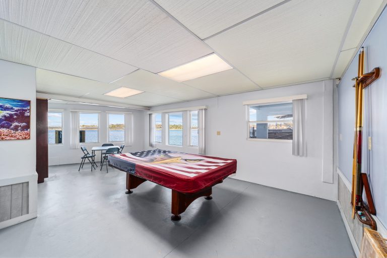 Game room pool table and waterfront windows
